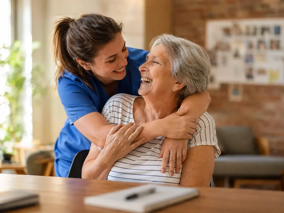 Compassionate caregiver with an elderly client at home